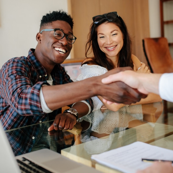 people shaking hands at a table